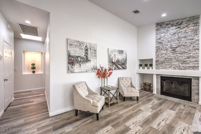 living area with a fireplace and hardwood / wood-style flooring