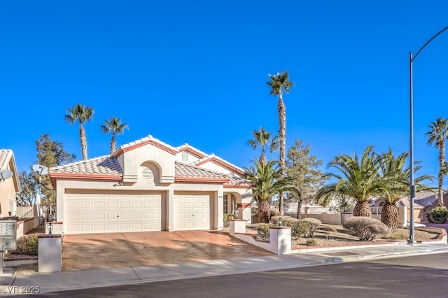 mediterranean / spanish-style home with a garage