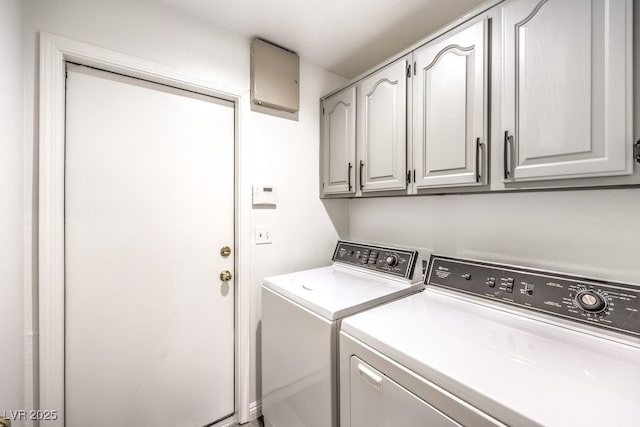 washroom with washing machine and dryer and cabinets