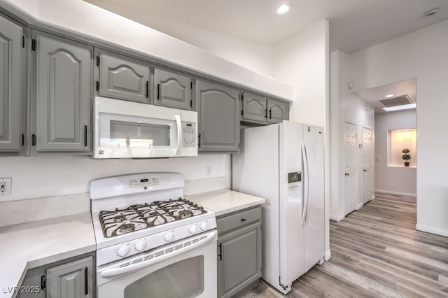 kitchen featuring white appliances and gray cabinetry