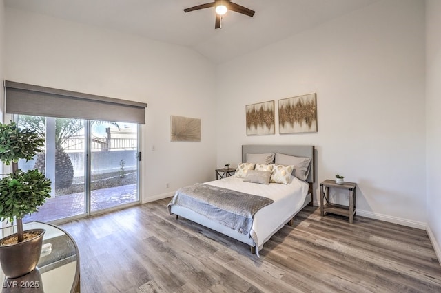 bedroom with ceiling fan, vaulted ceiling, hardwood / wood-style flooring, and access to exterior