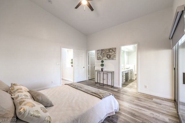 bedroom featuring ensuite bathroom, high vaulted ceiling, ceiling fan, and light hardwood / wood-style floors