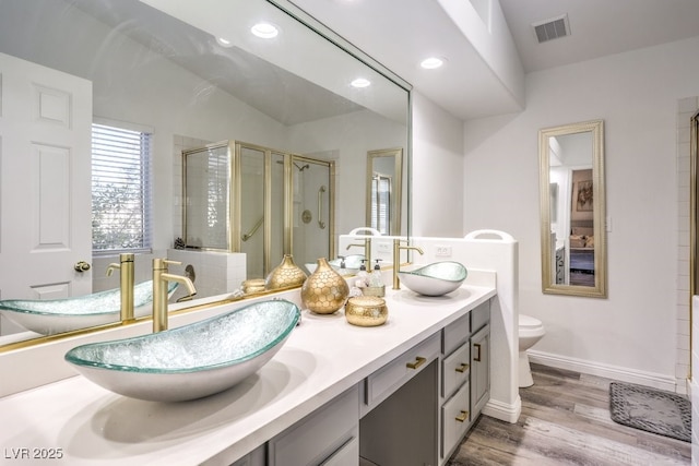 bathroom featuring toilet, walk in shower, vanity, and hardwood / wood-style floors