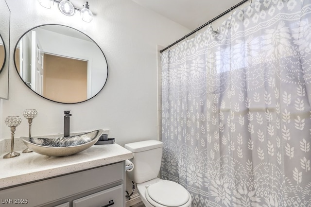 bathroom featuring toilet, walk in shower, and vanity