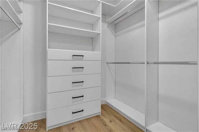 spacious closet featuring light hardwood / wood-style floors