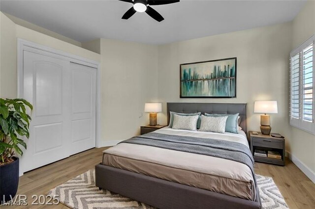 bedroom with ceiling fan, a closet, and light hardwood / wood-style flooring