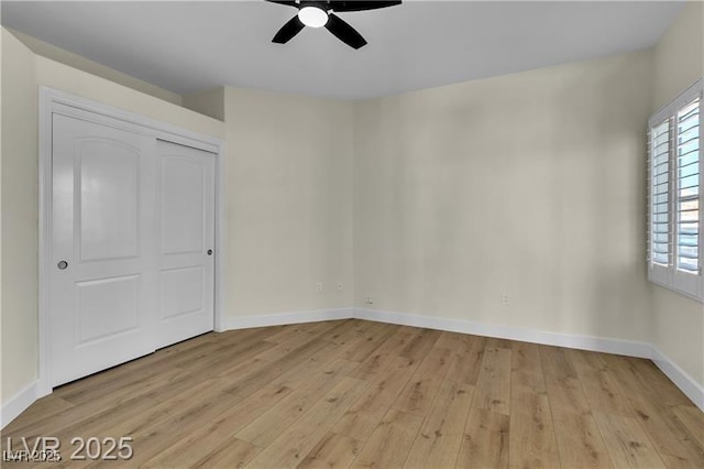 unfurnished bedroom with ceiling fan, a closet, and light wood-type flooring