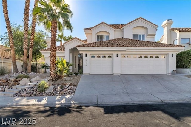 mediterranean / spanish house with a garage