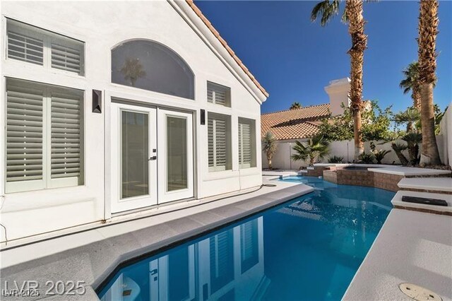 view of pool with french doors