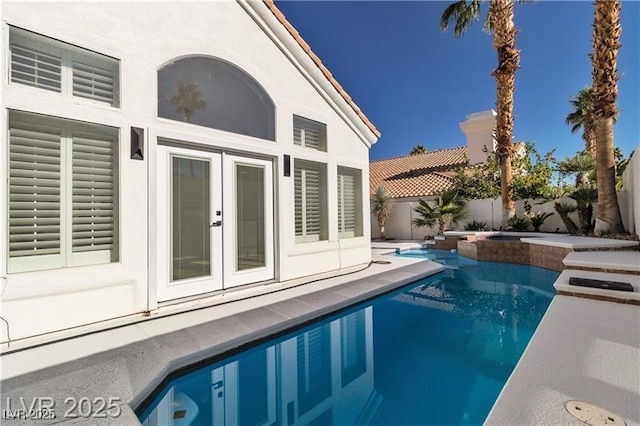 view of swimming pool featuring a fenced in pool, a patio area, french doors, and a fenced backyard