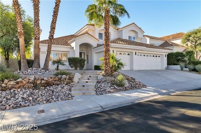 mediterranean / spanish-style home with a garage