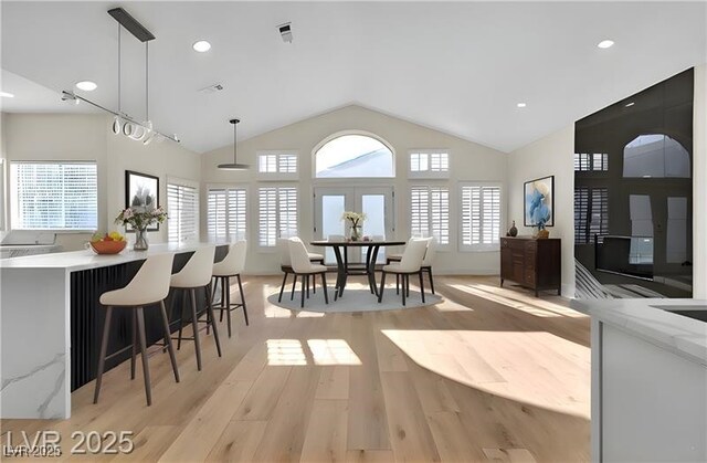 interior space featuring vaulted ceiling and light wood-type flooring