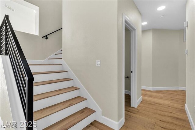 stairway with wood-type flooring