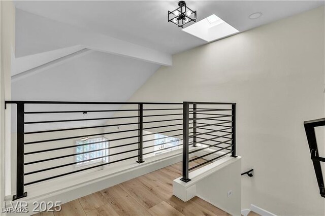 staircase featuring hardwood / wood-style floors, vaulted ceiling with beams, and a notable chandelier