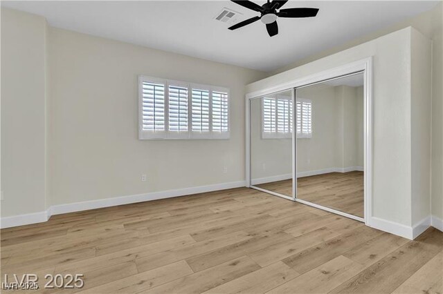 unfurnished bedroom featuring ceiling fan, a closet, and light hardwood / wood-style floors