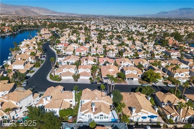 drone / aerial view with a water and mountain view