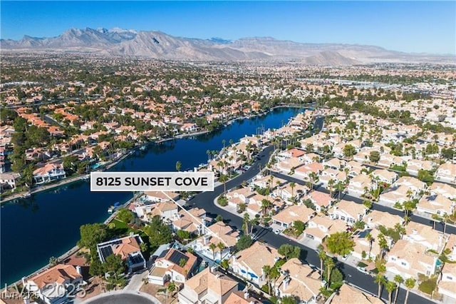 drone / aerial view featuring a water and mountain view