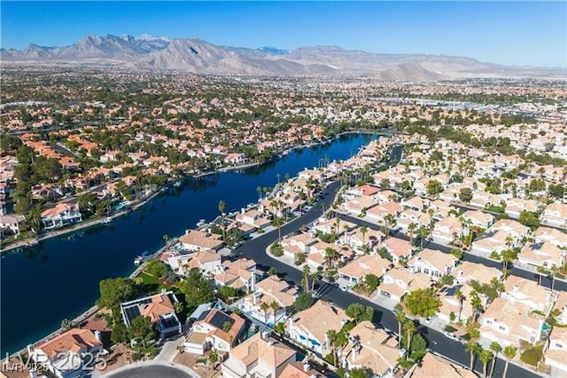 birds eye view of property with a water and mountain view