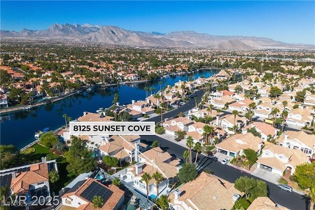 birds eye view of property featuring a water and mountain view