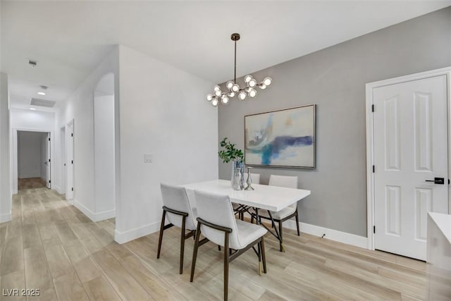 dining room featuring light hardwood / wood-style floors and an inviting chandelier