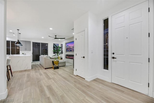 entryway with light hardwood / wood-style floors and ceiling fan