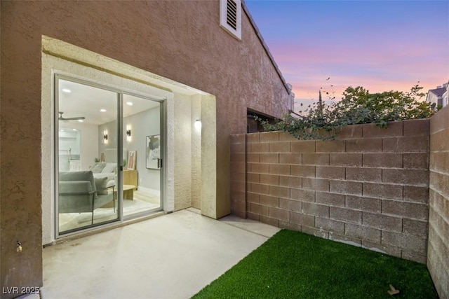 yard at dusk with a patio area