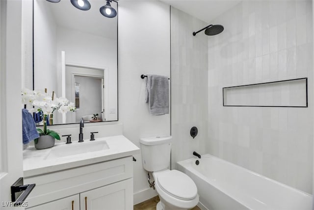 full bathroom with vanity, toilet, and tiled shower / bath