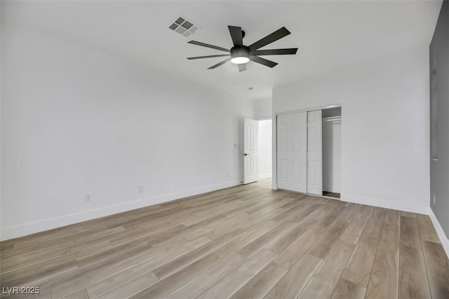 unfurnished bedroom with a closet, light hardwood / wood-style flooring, and ceiling fan