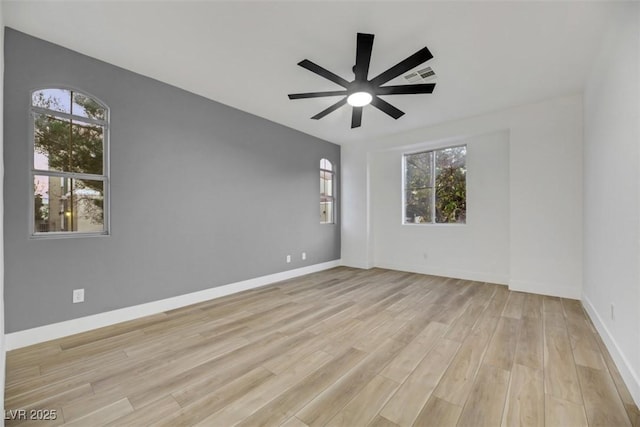 spare room featuring light hardwood / wood-style flooring and ceiling fan