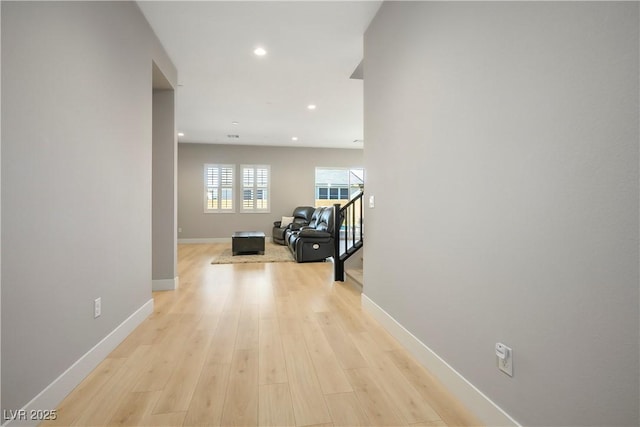 hallway with light hardwood / wood-style floors