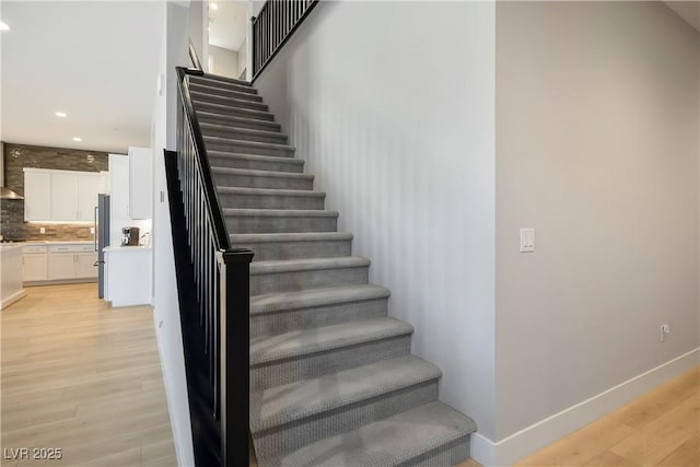 stairs with hardwood / wood-style flooring