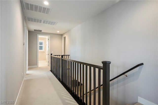 hallway with light colored carpet