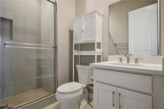 bathroom with vanity, a shower with shower door, and toilet