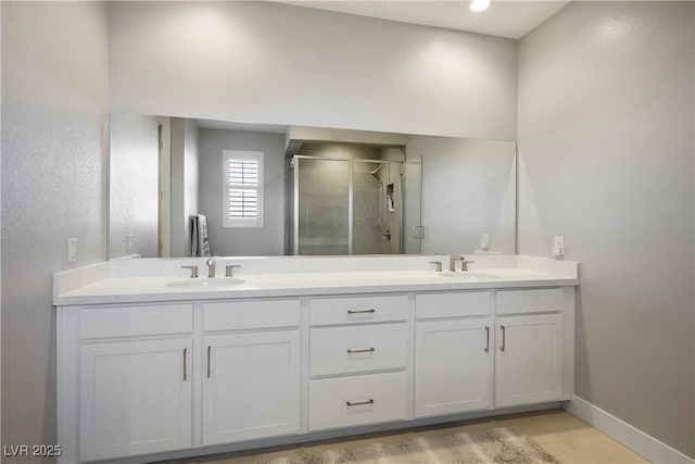 bathroom with a shower with door and vanity