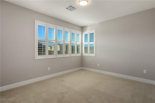 spare room with light colored carpet