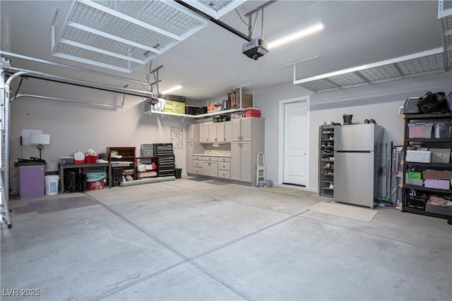 garage with a garage door opener and stainless steel refrigerator