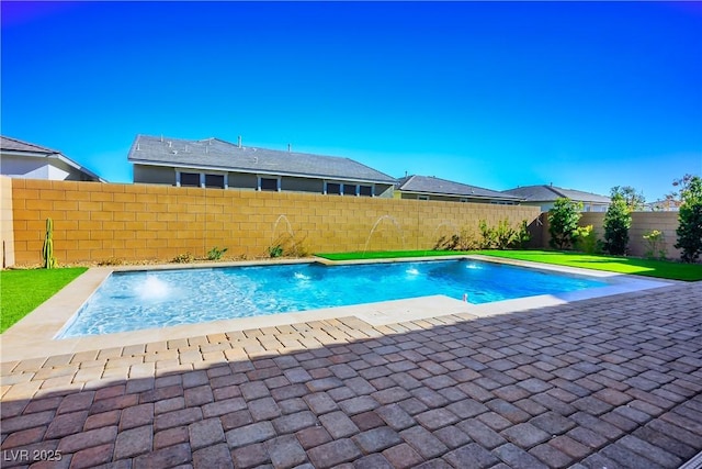 view of pool with a patio and pool water feature