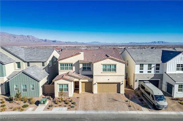 view of front of home with a garage and a mountain view