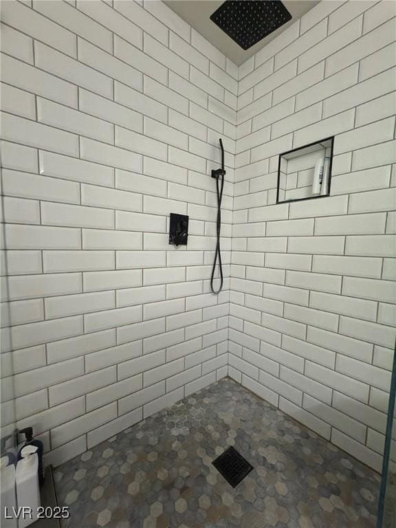 bathroom with a tile shower