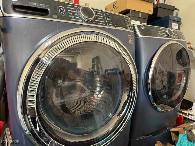 clothes washing area featuring washing machine and clothes dryer