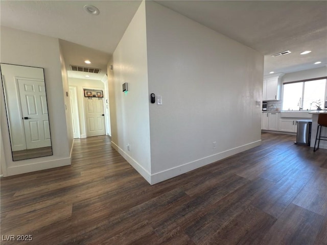 hall with dark hardwood / wood-style floors