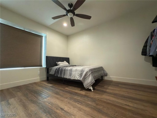 bedroom with dark hardwood / wood-style flooring and ceiling fan