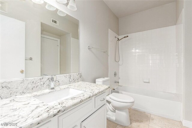 full bathroom featuring toilet, vanity, tile patterned flooring, and tiled shower / bath