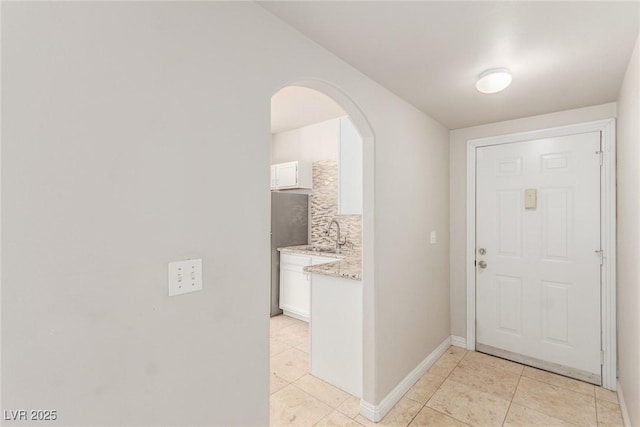 tiled foyer entrance featuring sink