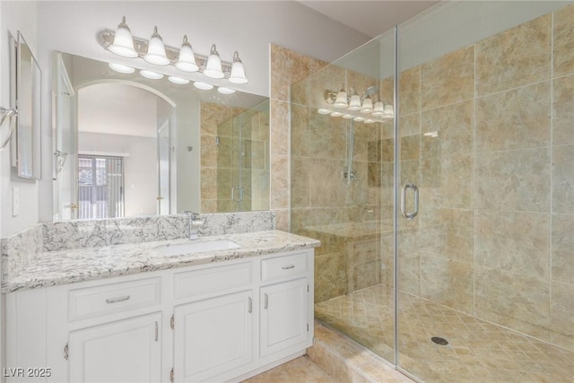 bathroom featuring vanity and a shower with shower door