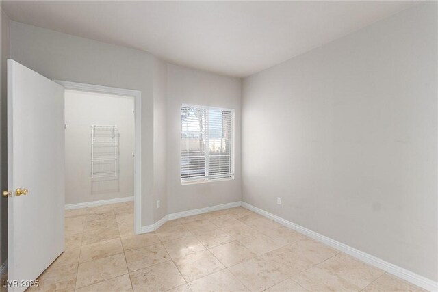 spare room featuring light tile patterned floors