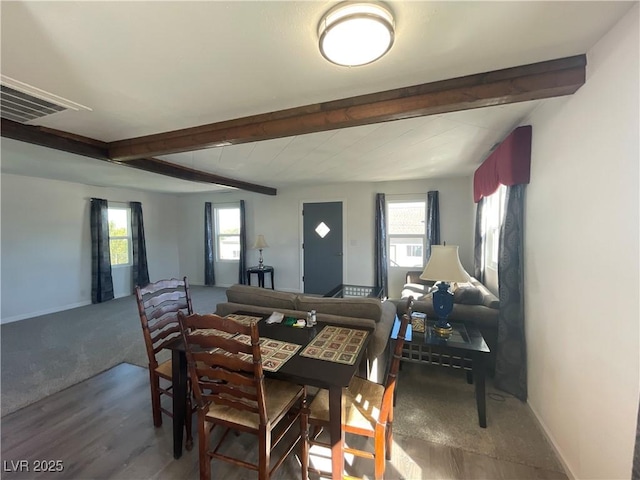 dining area featuring beam ceiling and wood-type flooring