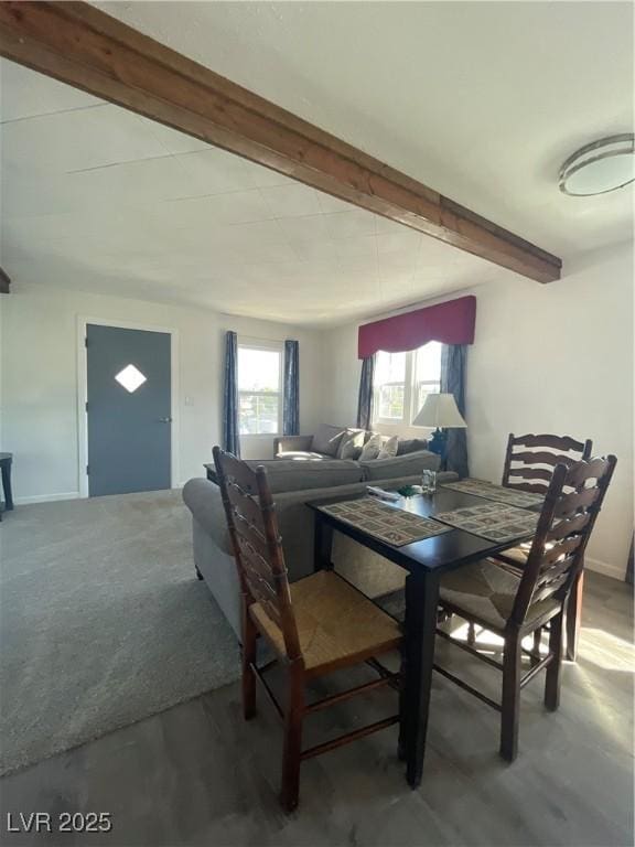 dining area featuring carpet floors and beam ceiling