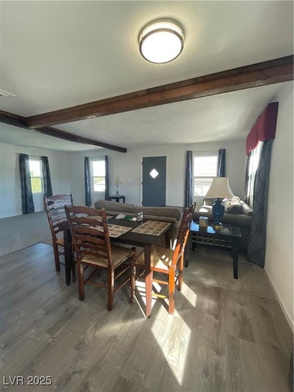 dining space featuring hardwood / wood-style flooring and beamed ceiling