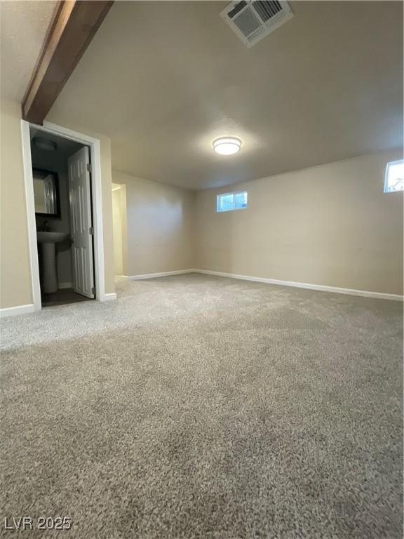 basement with sink and carpet flooring